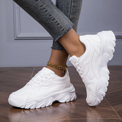 Women's white low-top lace-up sneakers for casual walks and shopping.