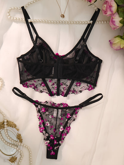 Stylish black lingerie set with floral embroidery, sheer mesh bra, low-rise thong, intricate back detailing, ideal for parties and everyday wear.