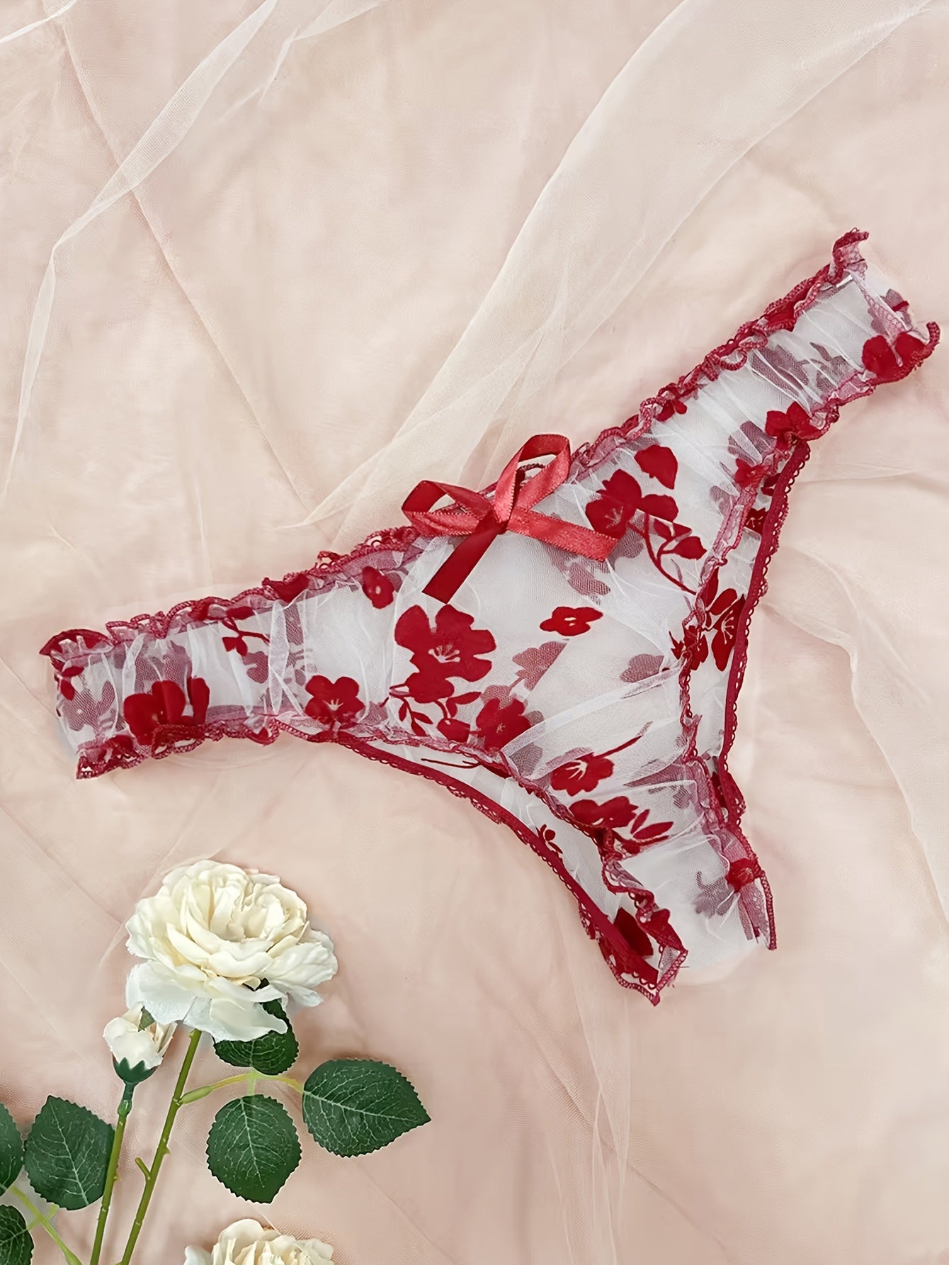 Lingerie set with floral print tulle, see-through bow bra, and tempting thong.