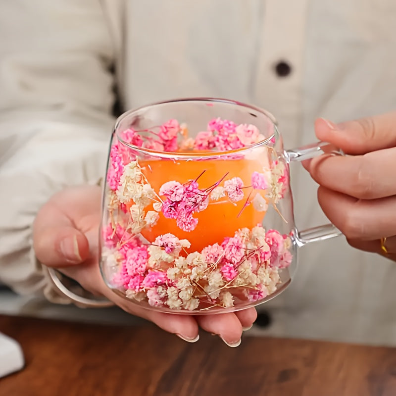 Elegant floral glass coffee mug with real dried flowers, double-walled insulated design in pink and clear. Hand wash only, BPA-free. Perfect for tea or coffee at home.