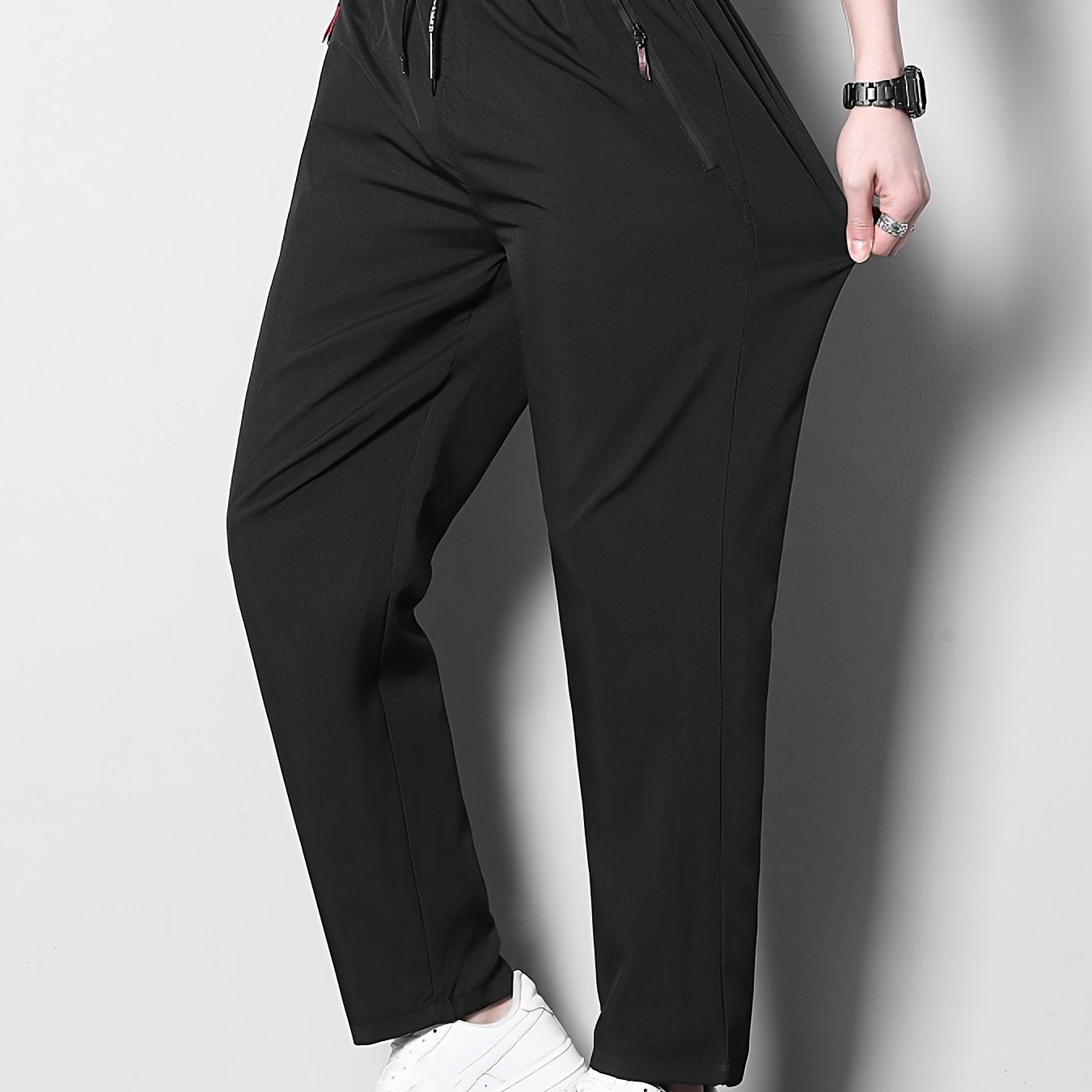 Men's plus size casual sports pants, made of stretchy polyester in a solid color with a regular fit, zipper detail, part of the spring/summer collection.