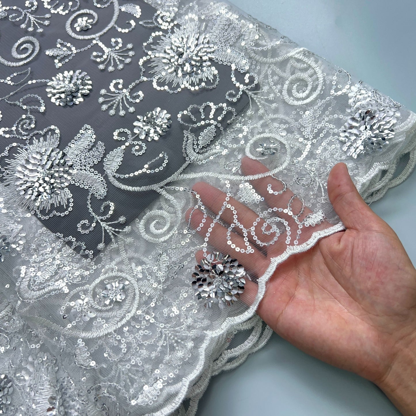 4.57 meter cut of Floral Sequin Tulle Lace Fabric, ideal for bridal gown sewing. Made of 100% Polyester, hand wash only.