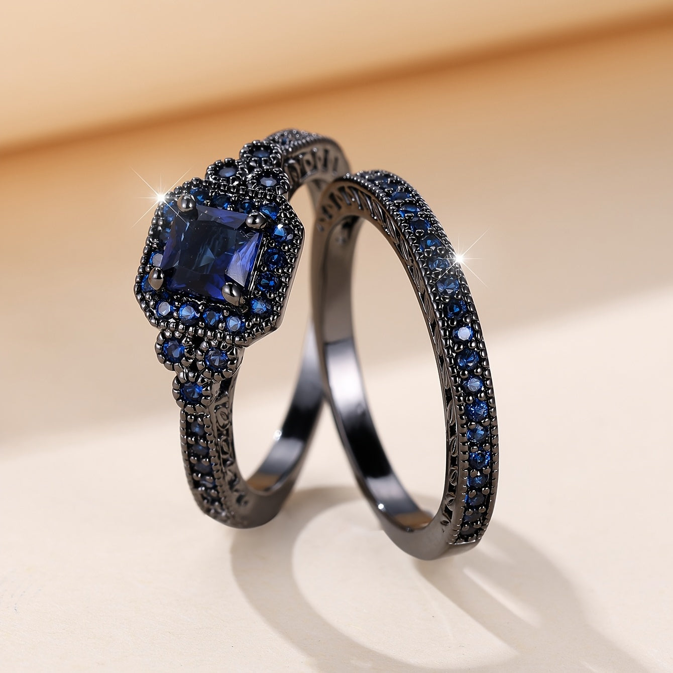 Set of 2 elegant promise rings featuring a halo ring with a dark blue zirconia stone and an eternity ring, perfect for engagement or wedding jewelry. Ideal for brides to enhance their evening party attire.