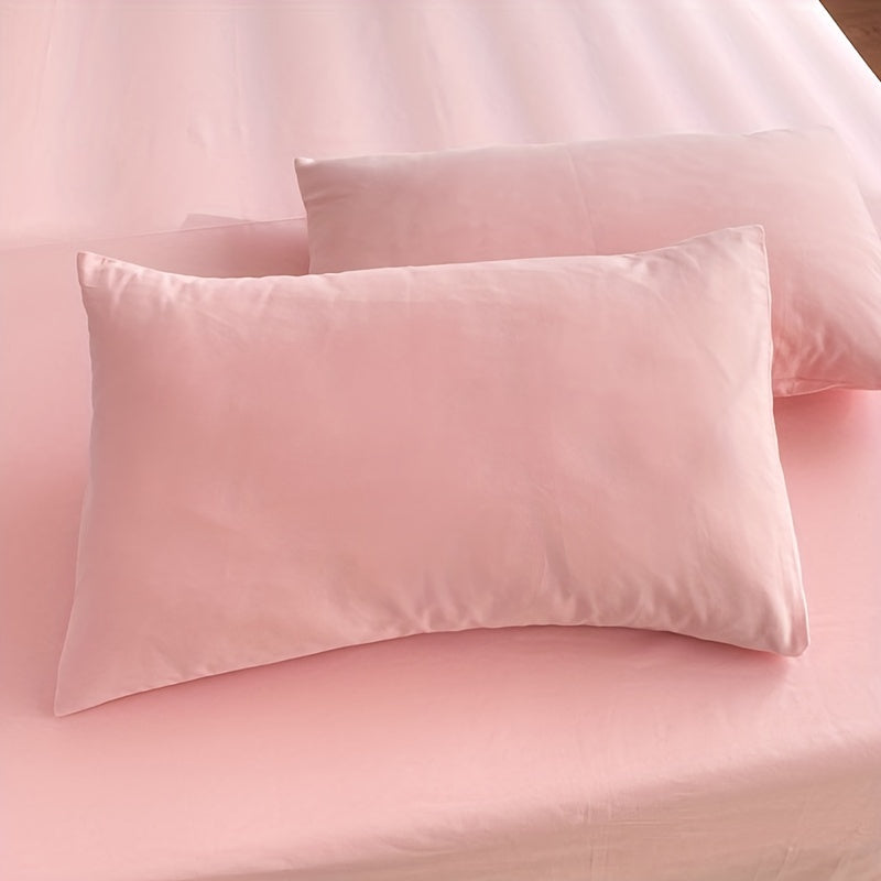 Two polyester pillowcases for bedroom use, featuring a multi-colored solid design.