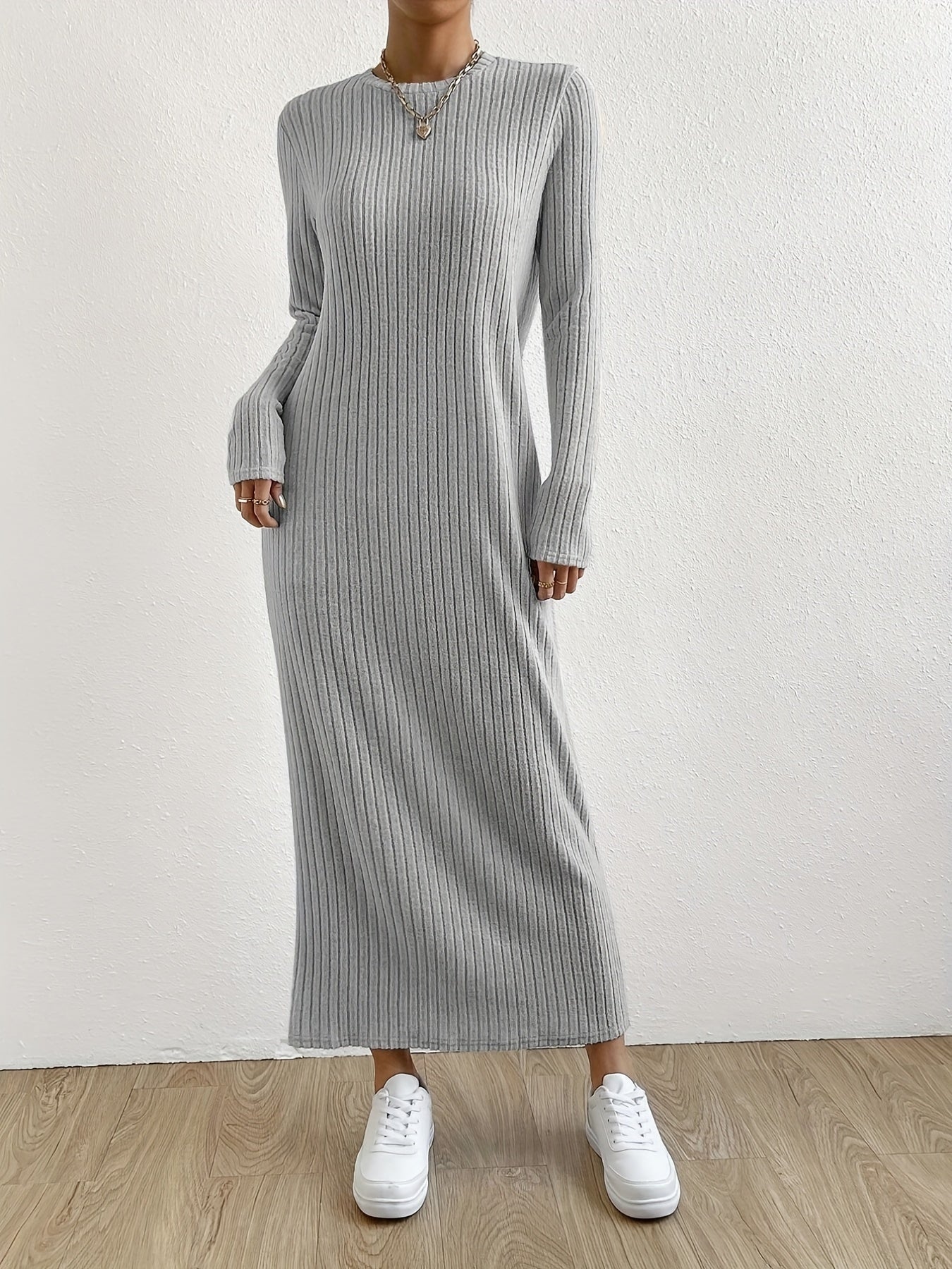 Elegant crew neck striped knit t-shirt dress made from a polyester and spandex blend. Features long sleeves and full-length ribbed knitwear for spring/fall.