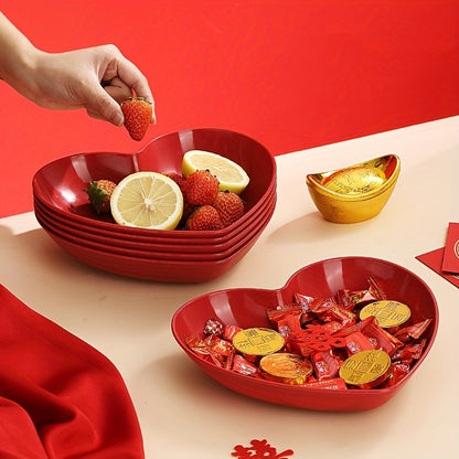 Heart-shaped plastic serving saucers in red for special occasions.