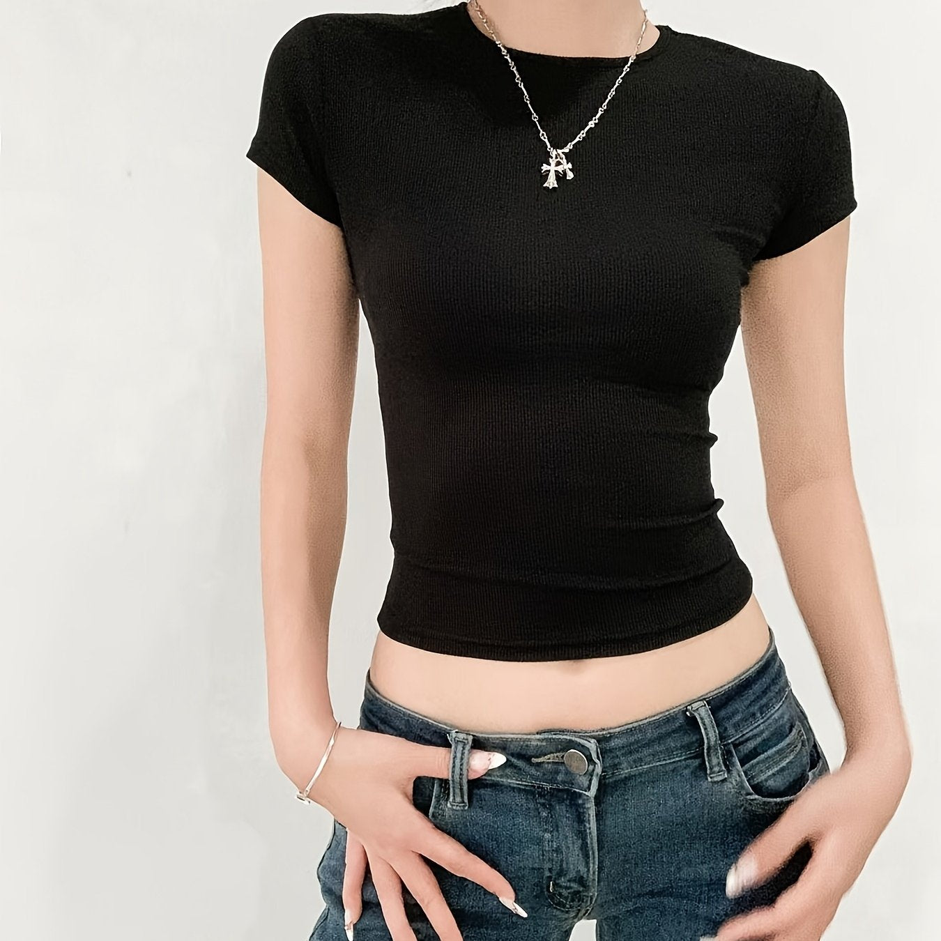 Women's ribbed short-sleeve t-shirt made of high elastic polyester and spandex blend. Features a round neck, slim fit, cropped length, and solid color. Perfect for a casual and sexy style