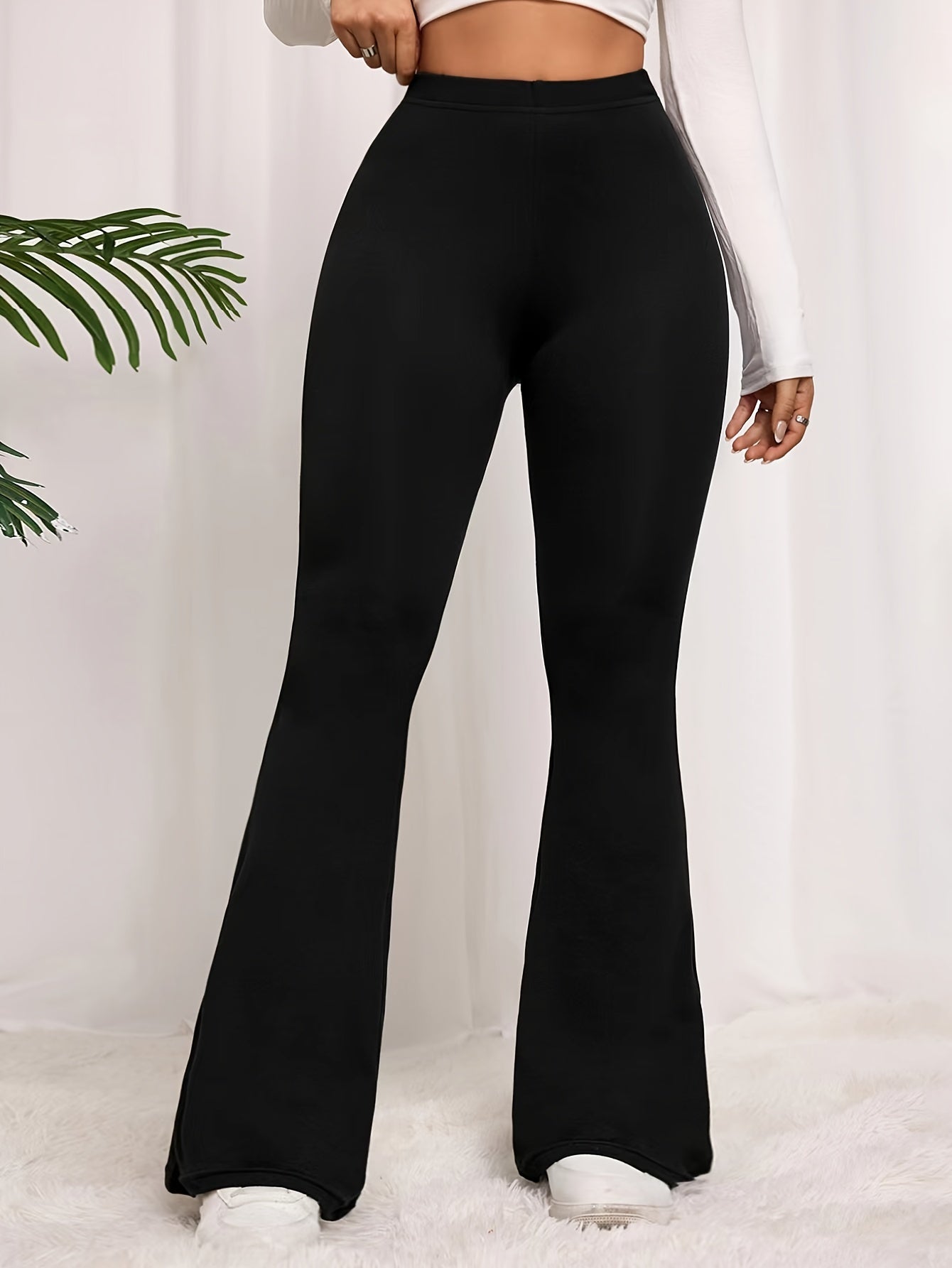 Solid color flared leg pants with a high waist, perfect for spring and summer in plus size women's clothing.