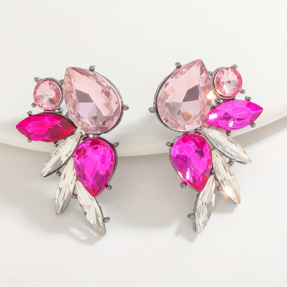 Add a touch of sparkle this Valentine's Day with our Pink Heart & Crystal Winged Drop Earrings. Featuring an elegant bling style, these earrings are made of Zinc Alloy with Stainless Steel Posts, perfect for weddings, parties, and gifts. The Round