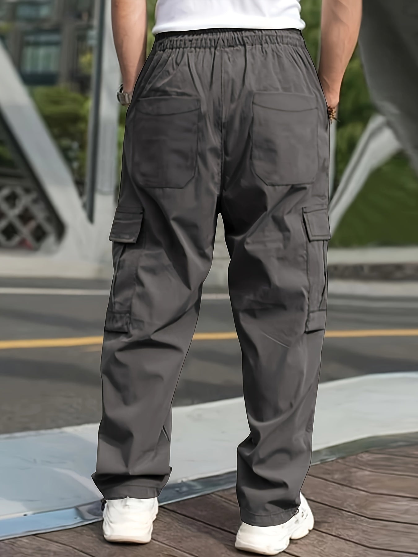 Men's cargo pants for outdoor activities with multiple pockets and drawstring waist.