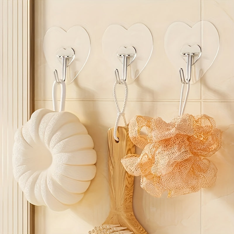 10-pack of heavy-duty adhesive hooks with clear plastic suction cups, heart-shaped wall mounts for kitchen and bathroom storage. Easy to install and perfect for casual style utility hooks.