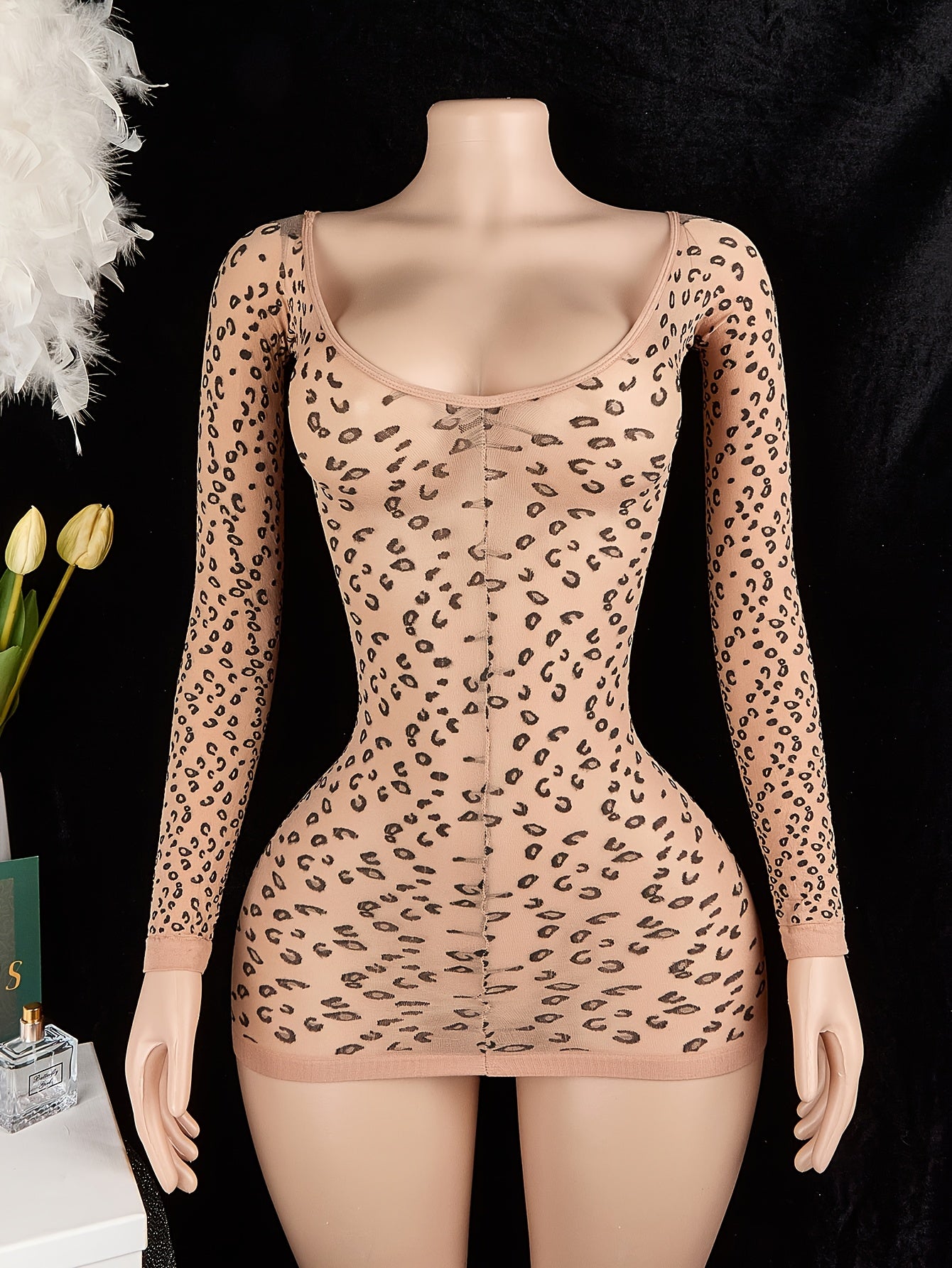 Leopard print bodycon bodysuit with long sleeves, backless design, and no padding. Made of 95% polyamide and 5% elastane. 100gsm lining. Adult size.