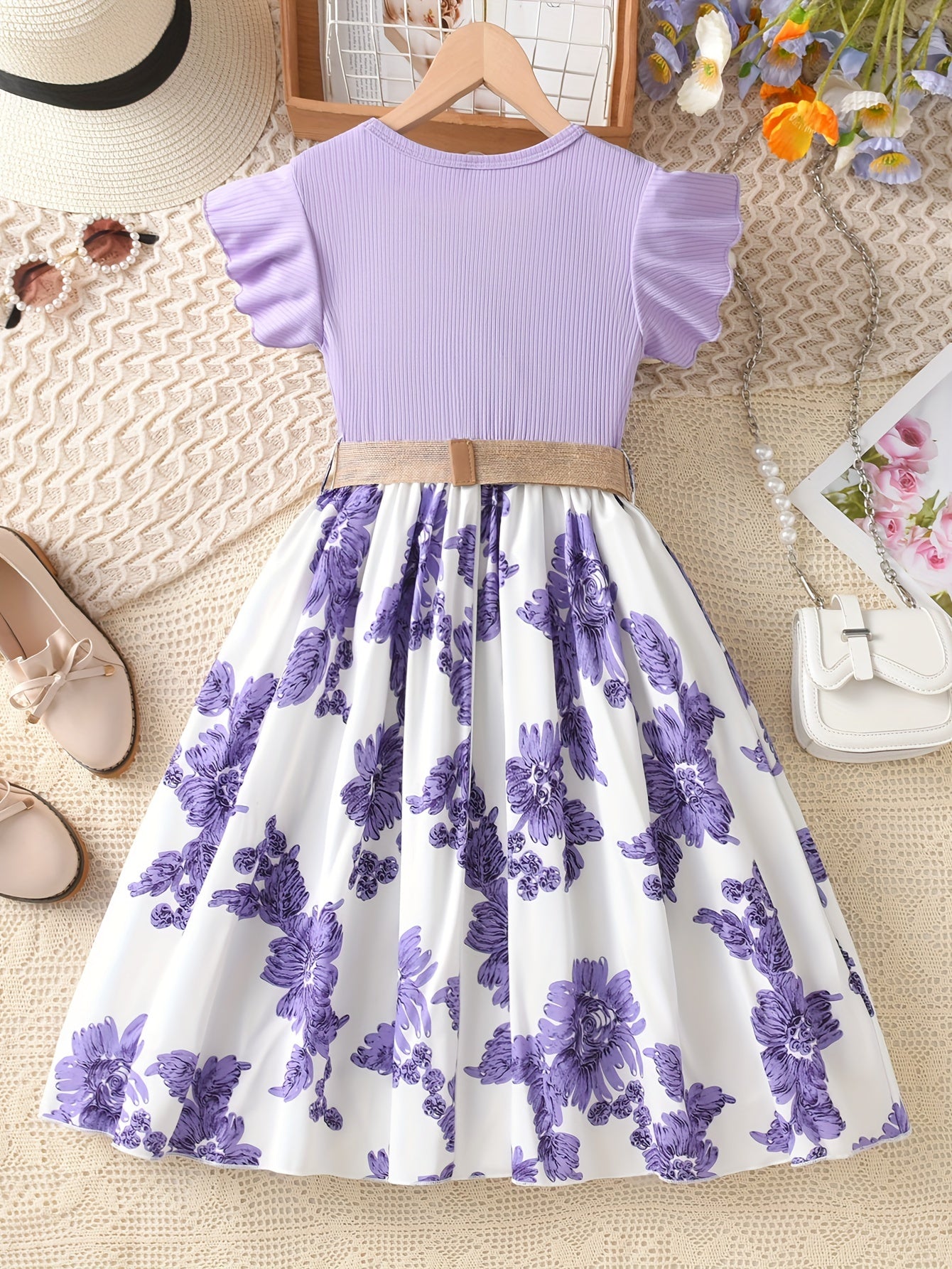 Summer floral dress for girls with ruffle sleeves, knee-length, polyester knit fabric, elastic waist belt, and flared hem in lavender & white floral print. Crew neckline and A-line