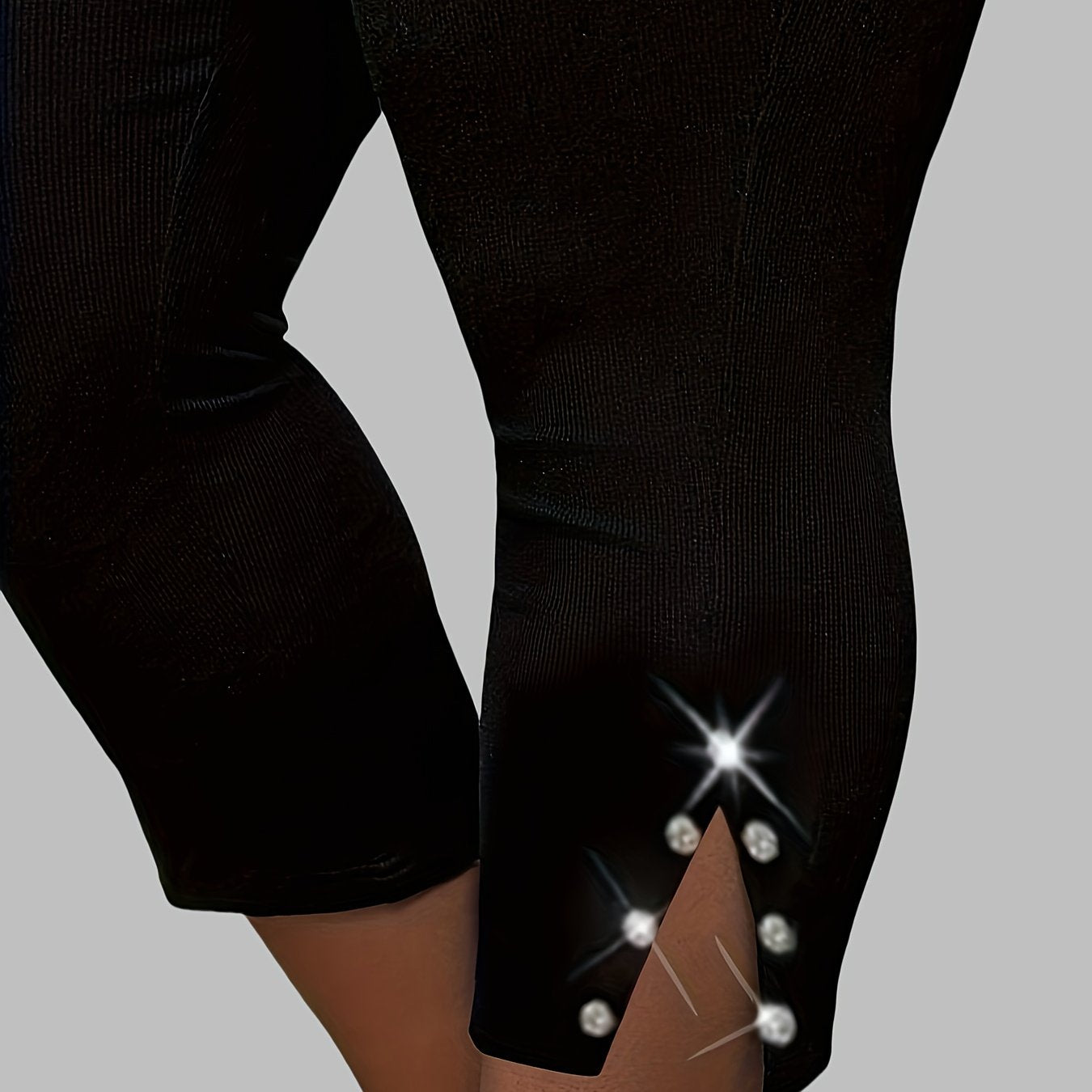 Polyester capri pants with rhinestone detail, slit hem, and high waist for outdoor activities.