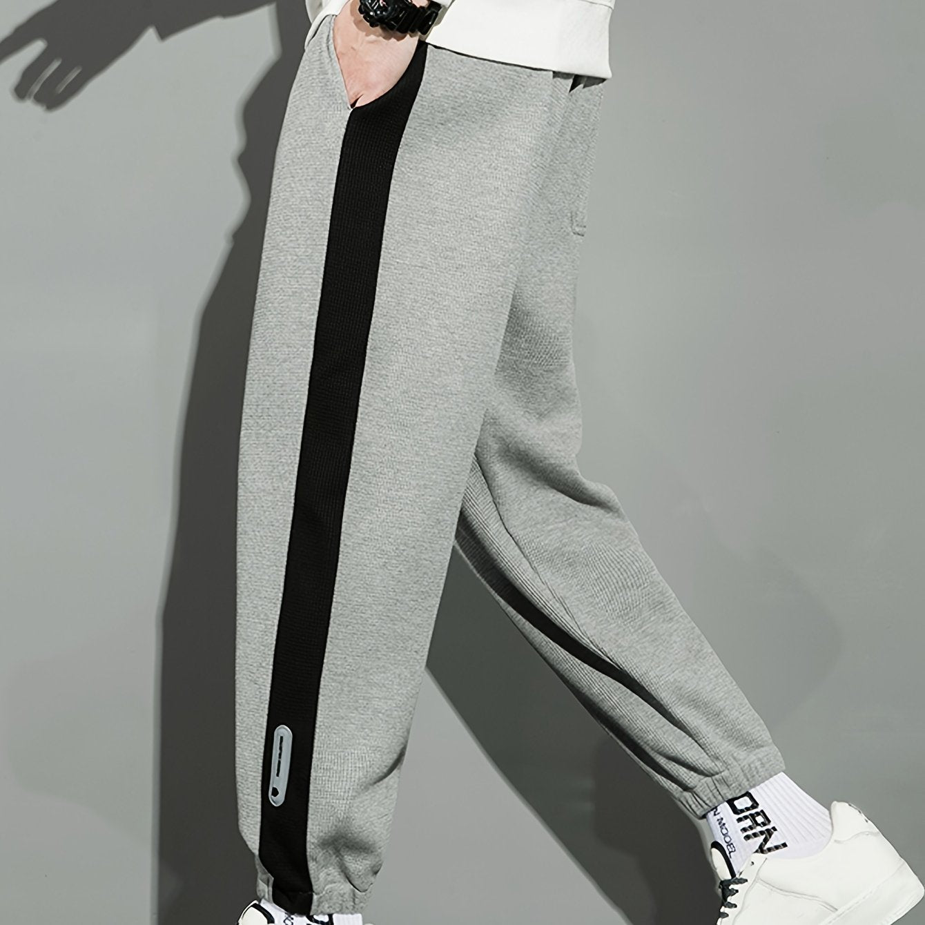 Men's casual joggers with contrast side stripe, elastic waist drawstring, regular fit tapered leg for leisure.