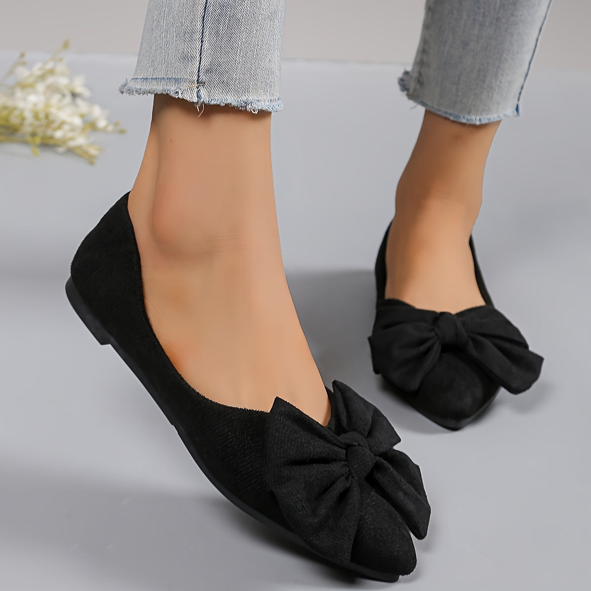 All-season slip-on flats for women with bow detail, fabric upper, rubber sole, and man-made insole. Versatile and stylish for work or casual wear.