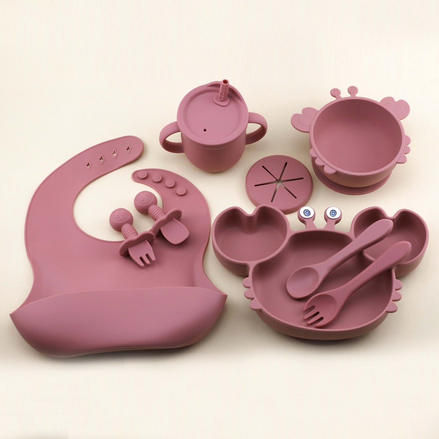 Set of 9 pieces of Silicone Feeding Essentials for Babies and Toddlers, featuring Silicone Bib, Suction Plate, Suction Bowl, Suction Straw Cup/Snack Cup, Spoon and Fork, Licking Spoon and Fork, all made of Food Grade Silicone in adorable shapes, offering