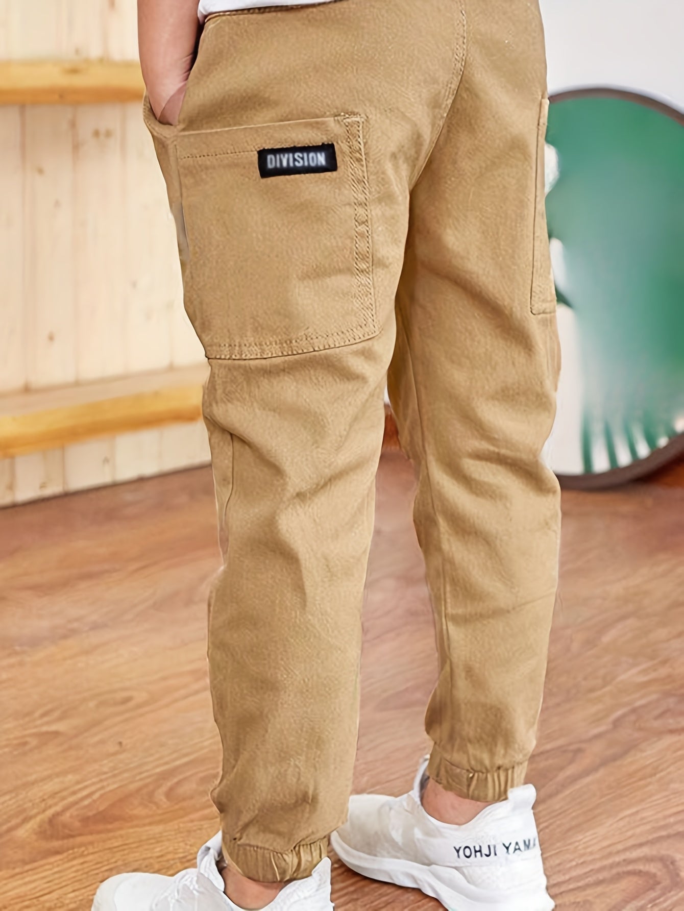 Boys' cotton cargo pants with elastic waist and pockets, ideal for casual and outdoor activities.