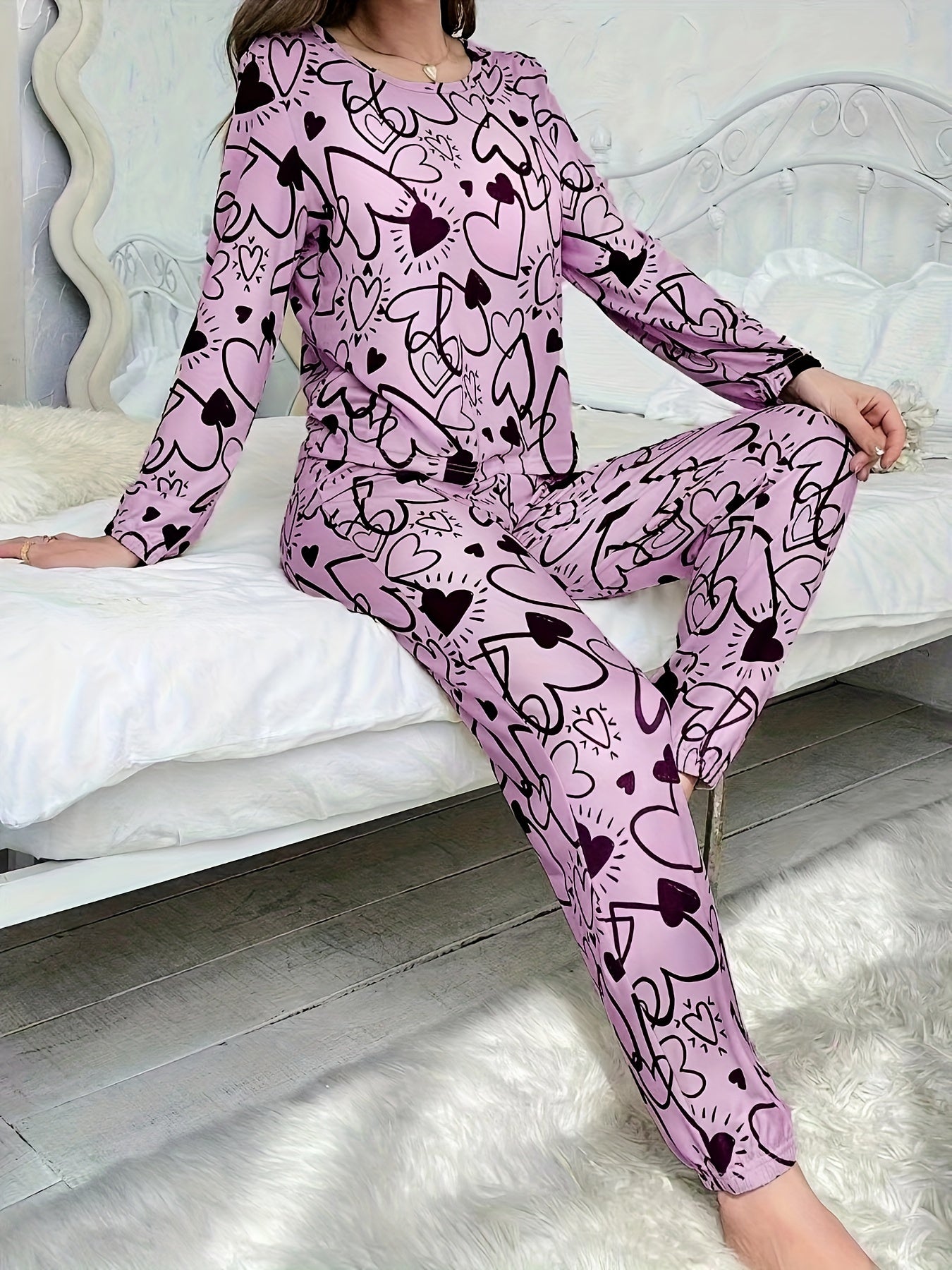 Women's lounge set with heart print, long sleeve top, crew neck, and elastic waistband pants for loungewear and sleepwear.