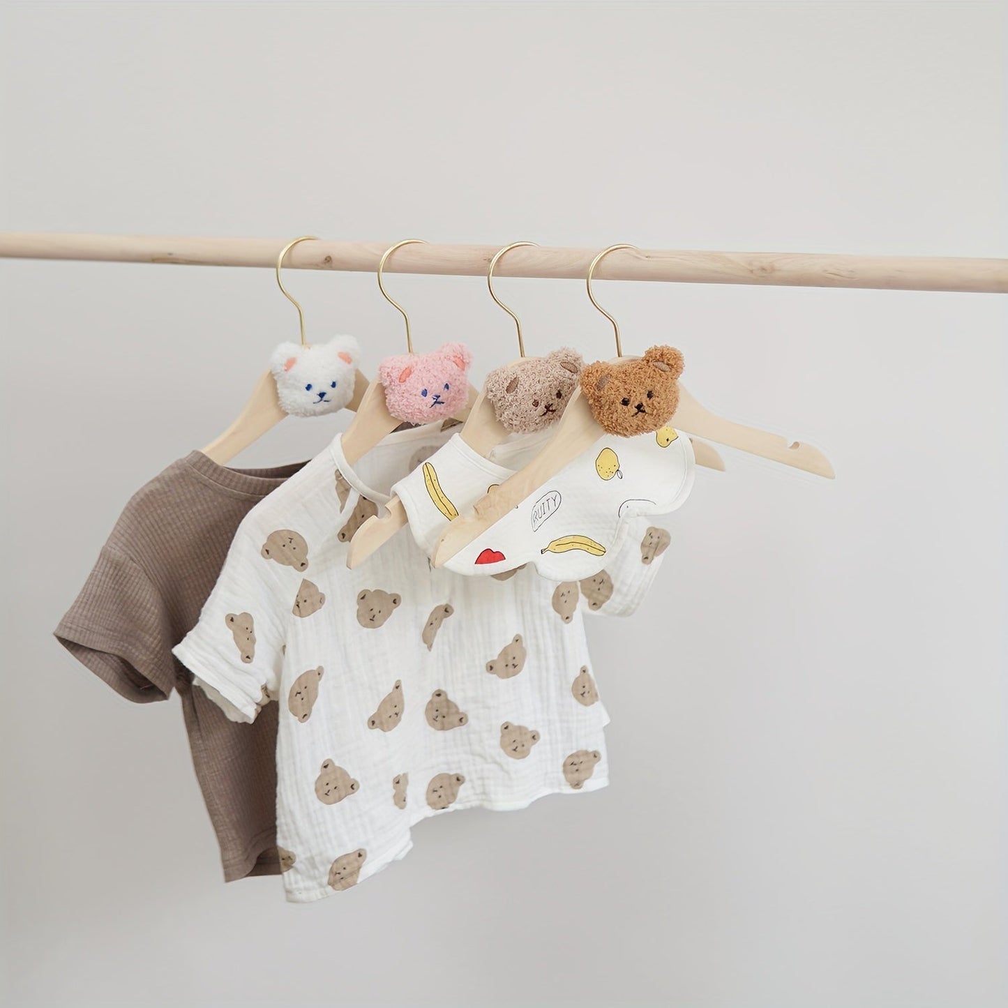 Durable and Lightweight Wooden Clothes Hangers featuring a Nordic Style Cartoon Bear Design, with Swivel Hooks for easy maneuvering. Recommended for Ages 14 and up.