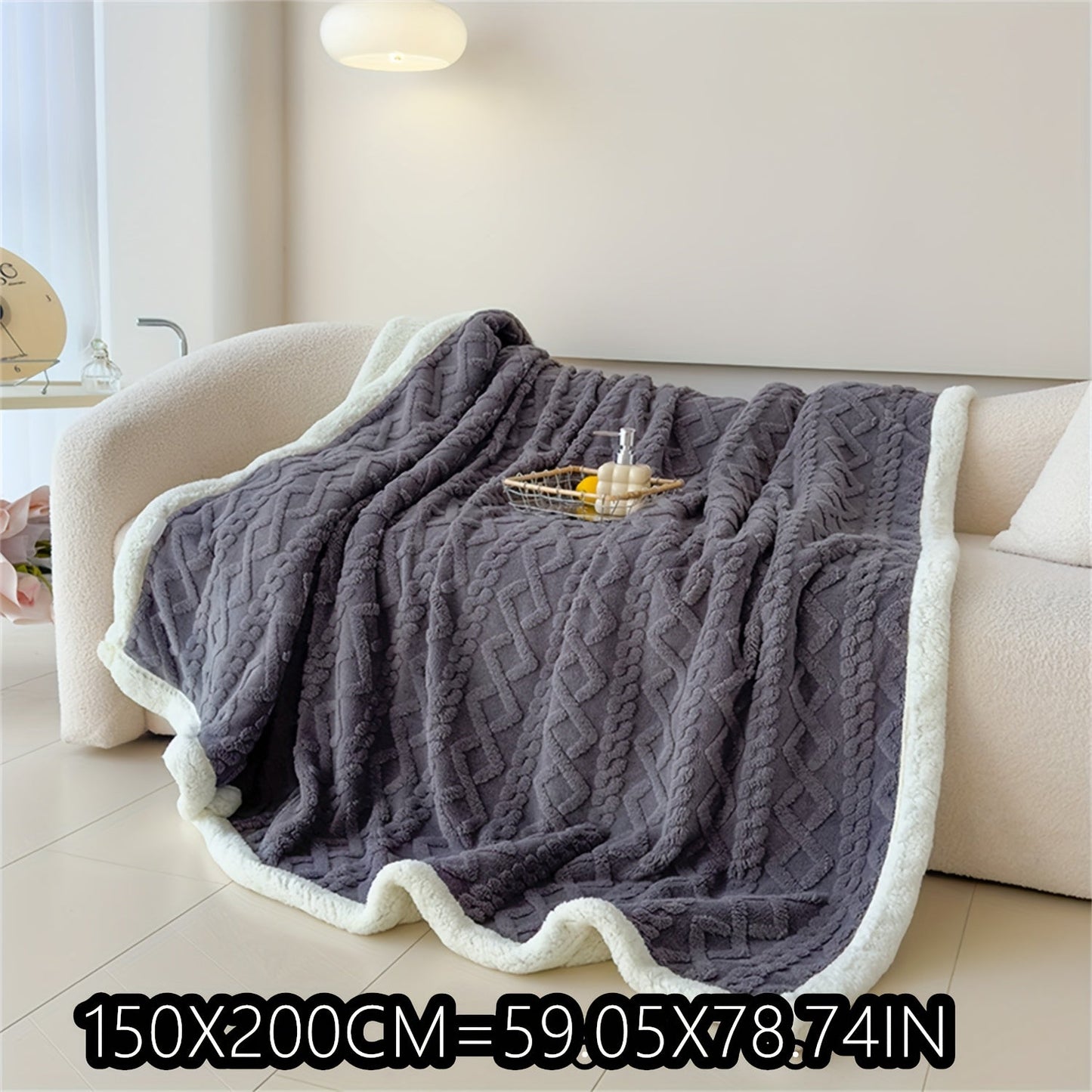 Soft cable-knit fleece blanket in blue, available in 150x200cm or 200x230cm sizes. Featuring a contemporary style, this blanket is machine washable and perfect for use in the bedroom, living room, office, or while camping during the winter. Made with a