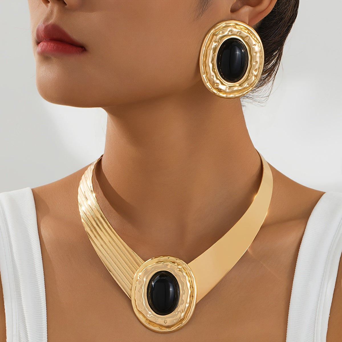 A stylish and modern set of golden pearl earrings and necklace for women, a stunning jewelry set that makes a statement - ideal for giving as a gift on special occasions.