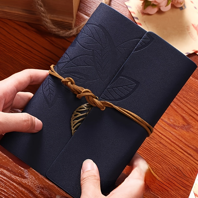 Vintage spiral-bound faux leather notebook with leaf-embossed design and strap closure, available in black, orange, and blue, perfect for students and travelers.