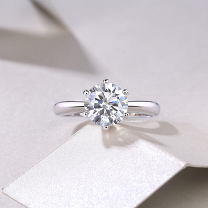 This stunning Classic Six-Prong Moissanite Promise Ring is available in 1, 2, 3, or 5 carat options. Crafted from 925 sterling silver and plated with 18k gold, this high-quality jewelry piece is perfect for engagements or marriages. It is a truly special