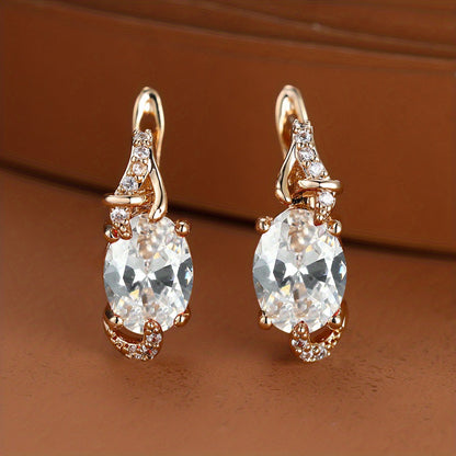 Trendy women's earrings featuring blue, white, red, and pink stones in round and oval cuts. These anniversary claw earrings are plated with 18K gold. Perfect for adding a pop of color to any outfit.