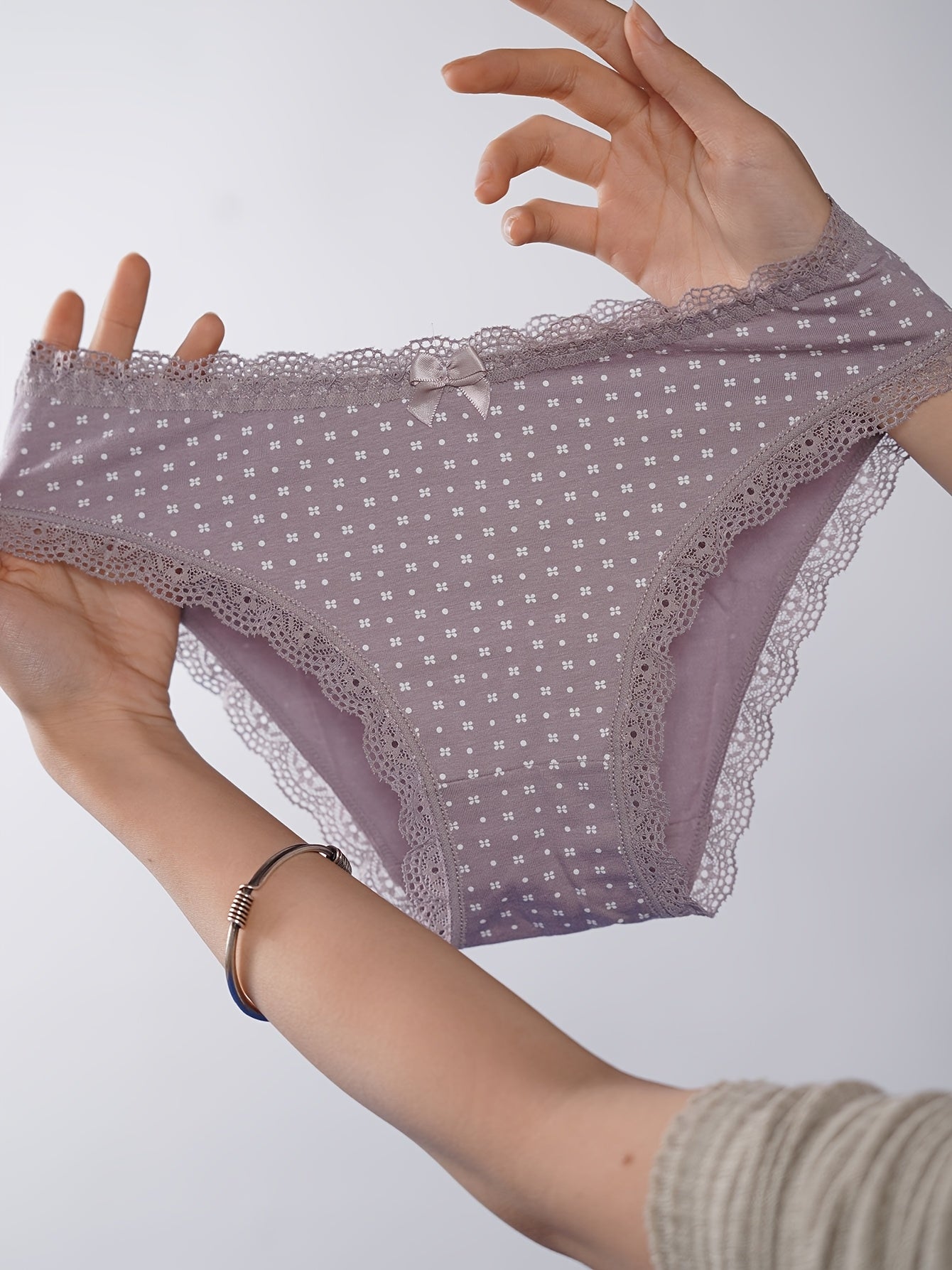 Women's briefs set with polka dot and stripe print, soft and breathable fabric, mid-rise fit with bow detail.