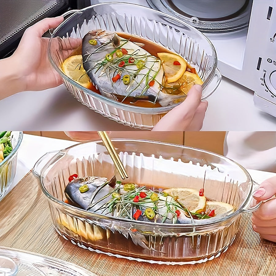 Oval clear glass casserole dish with lid and handles, versatile for microwave, oven, and dishwasher use - ideal for preparing fish, salads, and pasta.