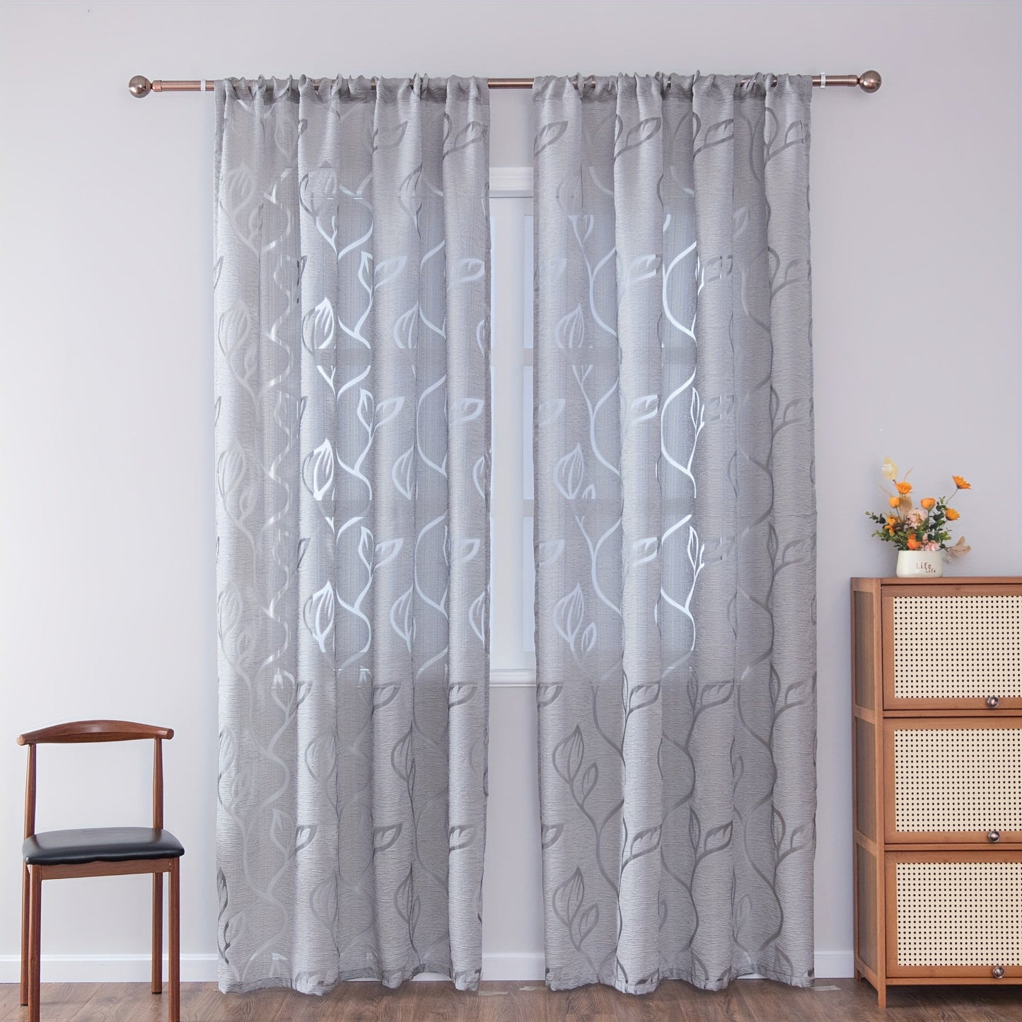 Elegant and contemporary gray floral sheer curtain with a rod pocket design, perfect for enhancing the decor of your living room, bedroom, or home.