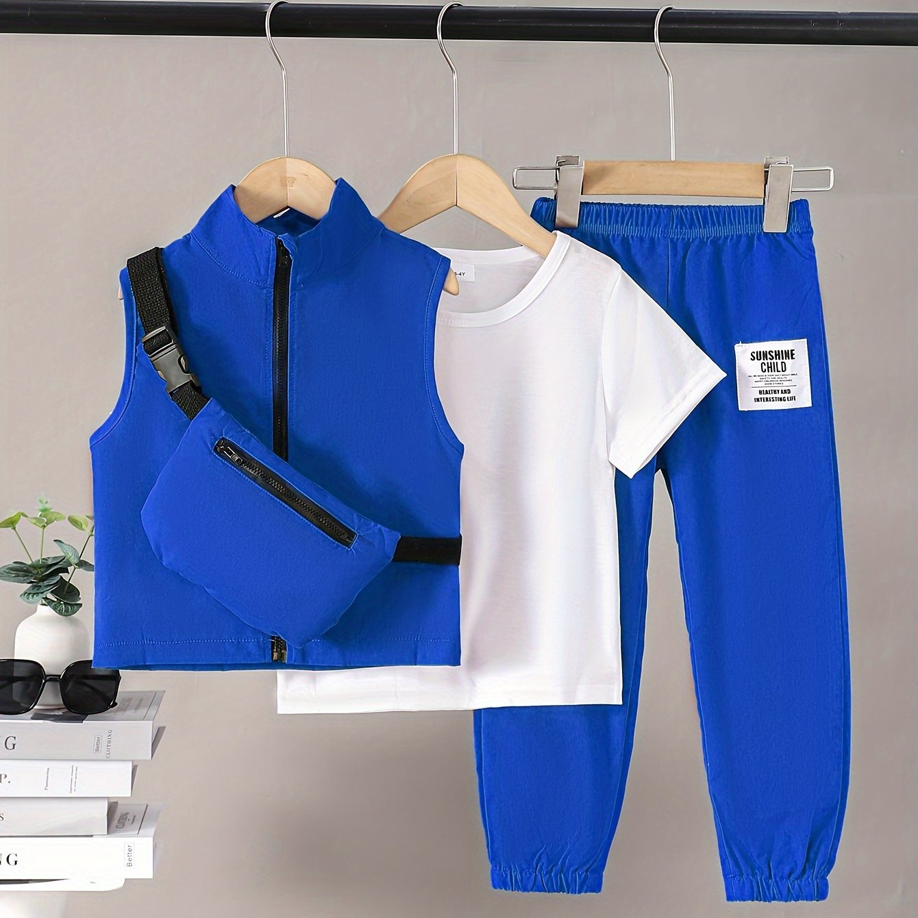 Boys 4-piece spring outfit: Short sleeve t-shirt, sleeveless vest, cargo pants, and crossbody bag. Cool, lightweight, and comfy for outdoor wear.