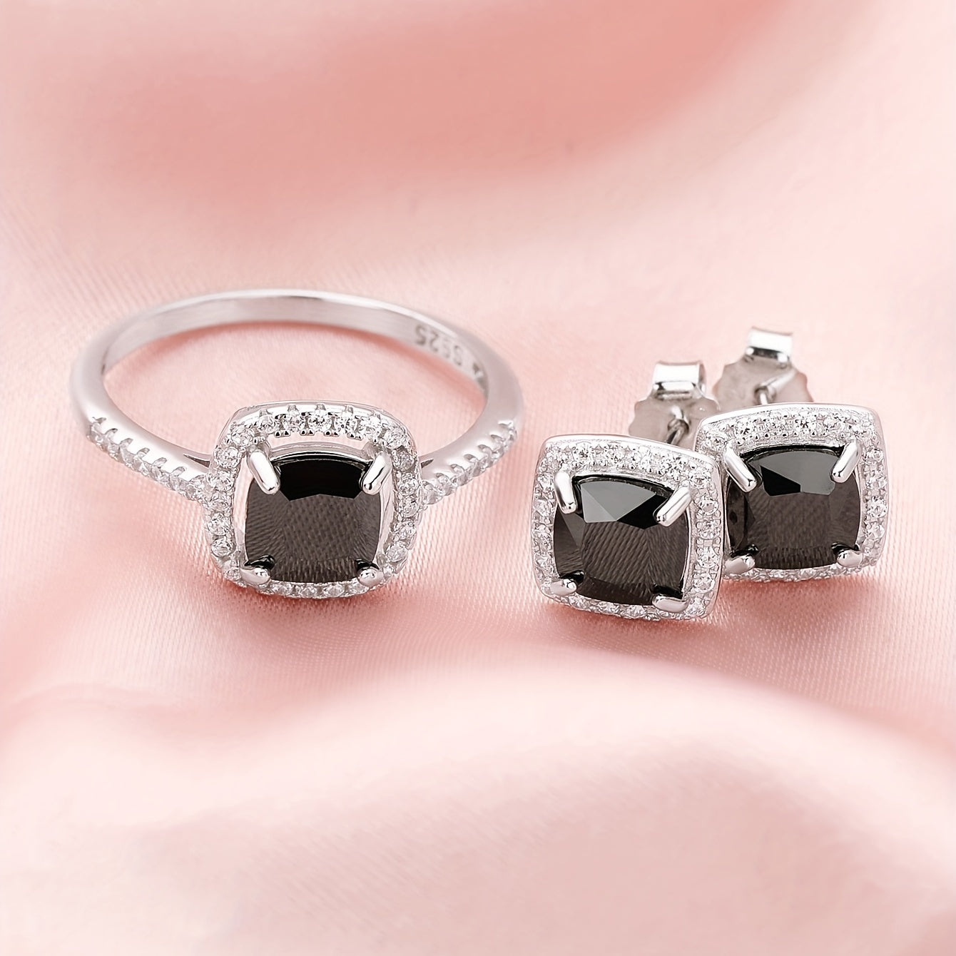 Set of elegant jewelry comprising of three pieces - two earrings and one ring, made of 925 sterling silver and inlaid with black zircon. This set symbolizes romance and mystery, making it perfect for parties and special occasions. The total weight of