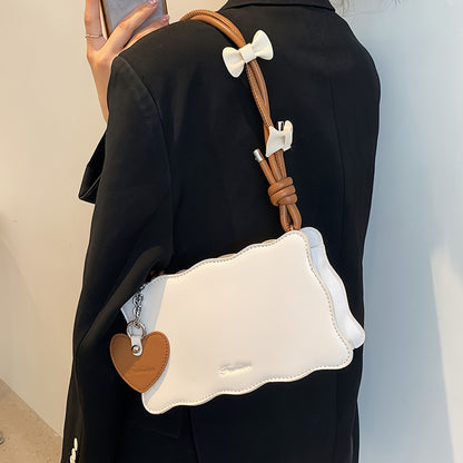 Baguette shoulder bag made of PU material with butterfly bow accents. Versatile and chic fashion accessory.