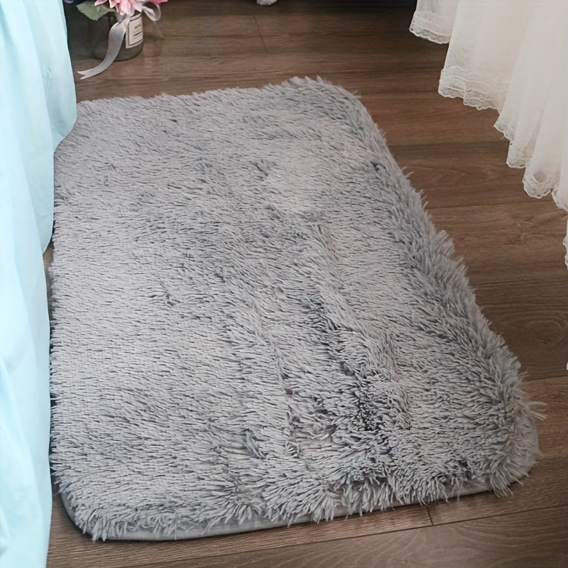 Soft and luxurious light gray plush floor mat with non-slip backing for ultimate comfort and safety. Made of ultra soft, fluffy polyester, this mat is perfect for use in the bedroom, bathroom, or living room. It is machine washable, making it easy to