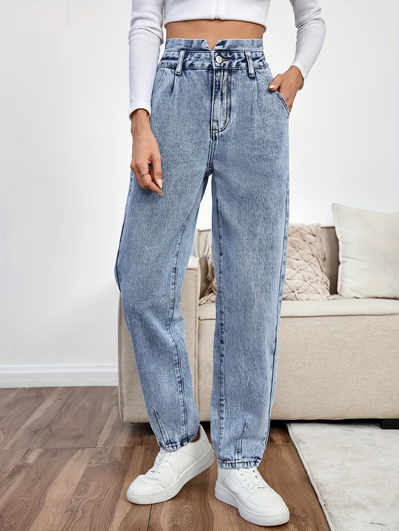 Women's light blue high-waisted straight-leg denim jeans with slash pockets, button closure, and non-stretch cotton material for casual spring/fall wear.