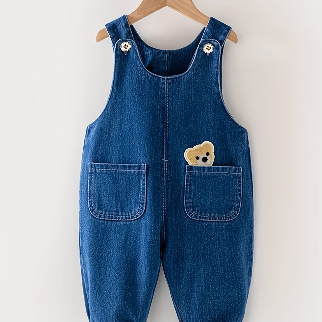 Children's denim overalls with animal pocket detail, made from a cotton blend fabric. Ideal for spring and fall seasons, this unisex toddler jeans romper is perfect for outdoor play.