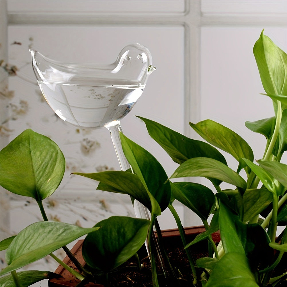 Set of 5 self-watering bird-shaped globes for automatic watering of flowers and gardening tools at home.