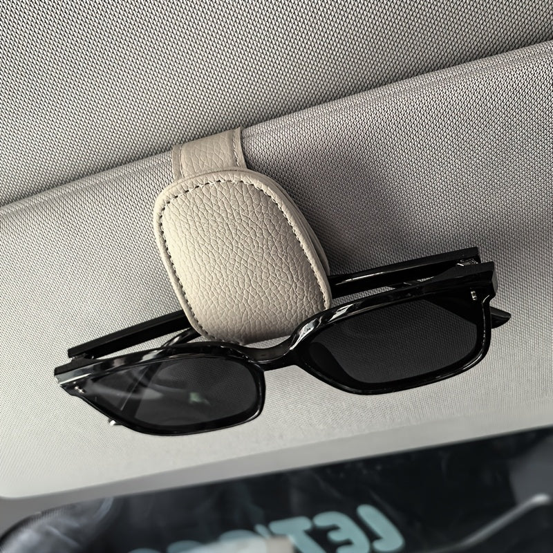 Universal car sun visor clip made of PVC material for storing eyeglasses in the vehicle interior.