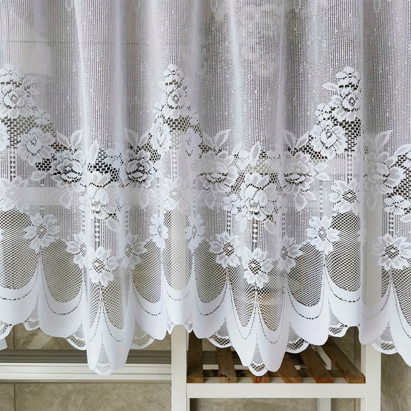 Bring elegance to your windows with our 1-piece White Lace Sheer Curtain featuring delicate floral patterns. This curtain has a rod pocket, scalloped bottom, and is made of lightweight polyester voile, perfect for dining rooms and kitchens. It is