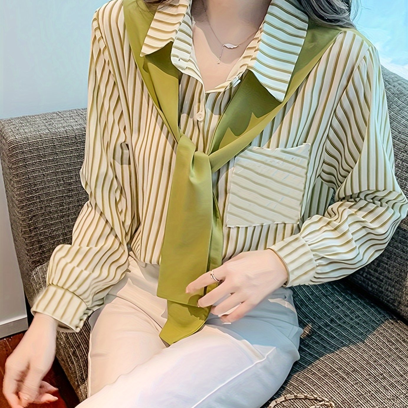 Elegant striped lace-up shirt with long sleeves and single breasted placket made of polyester, perfect for adults in spring/fall. Features a square neck.