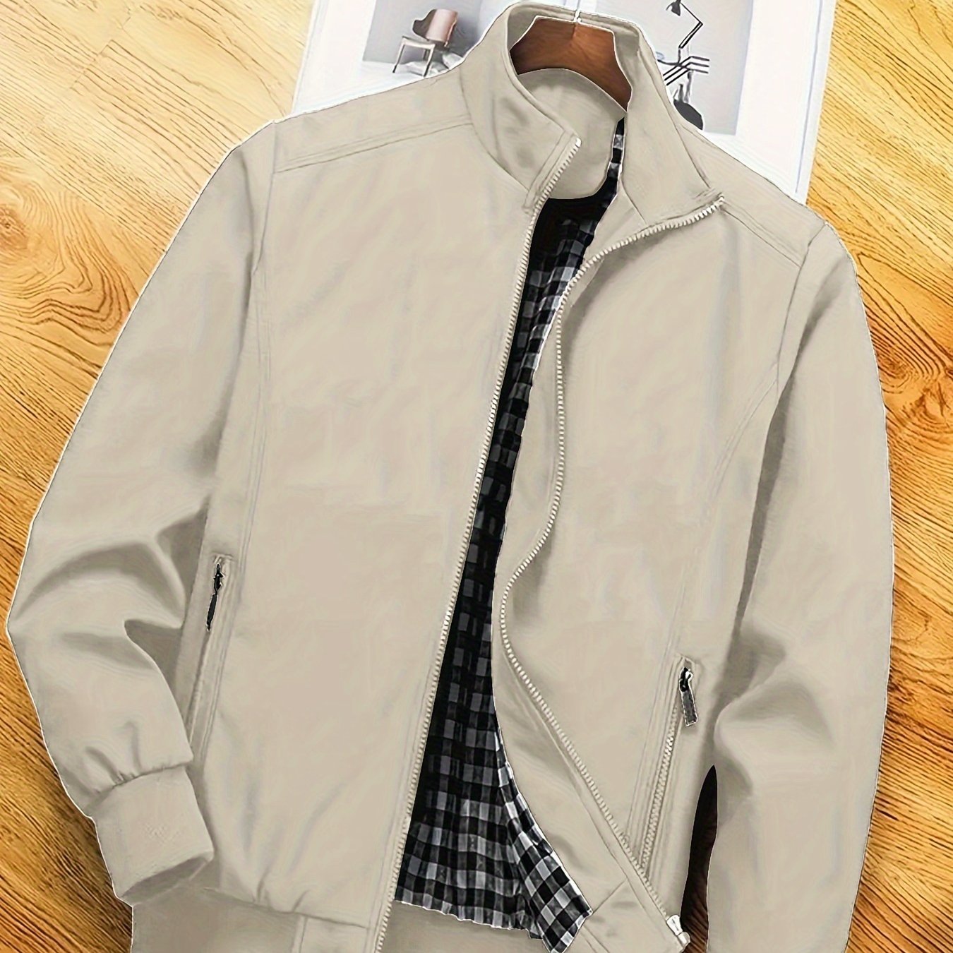 Men's casual spring/autumn polyester jacket with stand collar, zipper pockets, and solid long sleeves for outdoor and workwear.