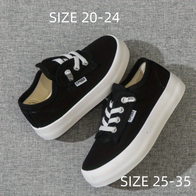 Children's preppy casual low top sneakers with solid color fabric upper and rubber sole. Features round toe, breathable cloth insole, elastic band closure, lightweight design, splicing