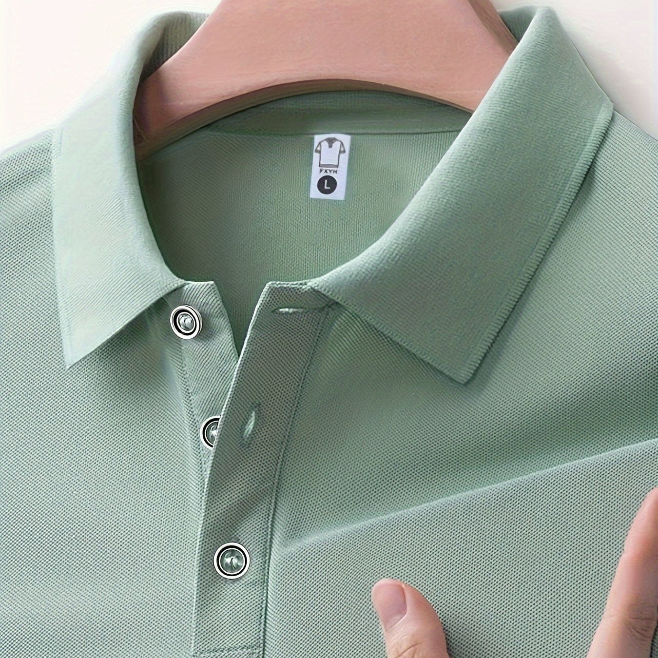 Men's summer casual short sleeve shirt in green, made of 100% polyester knit fabric with slight stretch. Regular fit with solid color lapel collar and button details. 145G/M².