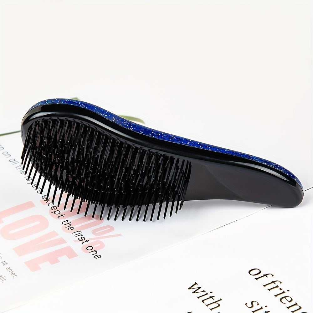 Portable, tiny massage comb for detangling hair with a starry sky design.