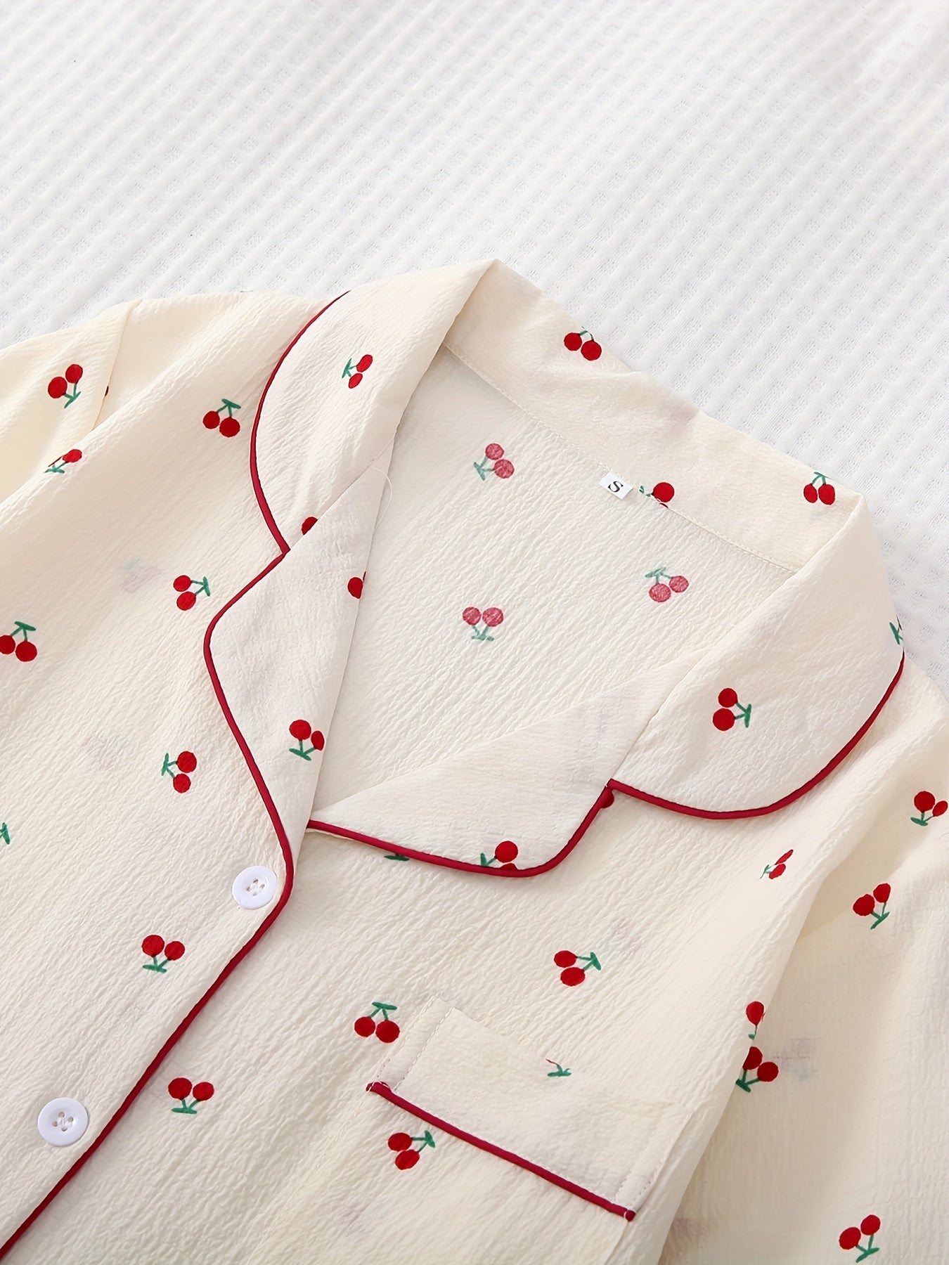 Cherry print pajama set featuring lapel button top and bow shorts, perfect for women's sleepwear and loungewear.