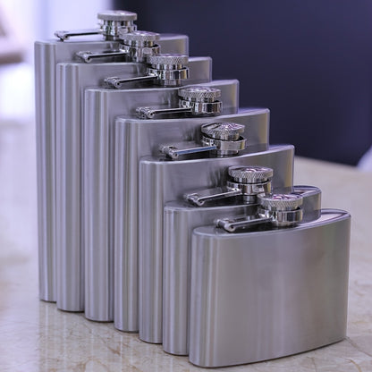 Portable stainless steel hip flask for alcohol, with screw cap and pocket-sized design for outdoor use.