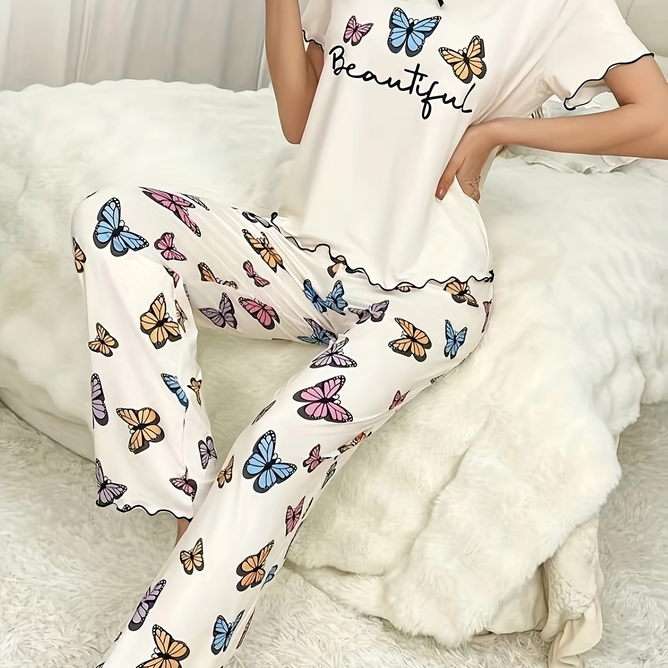 Women's casual lounge set with butterfly and letter print, frill trim, short sleeves, round neck top, and matching pants for a comfortable and relaxed fit.