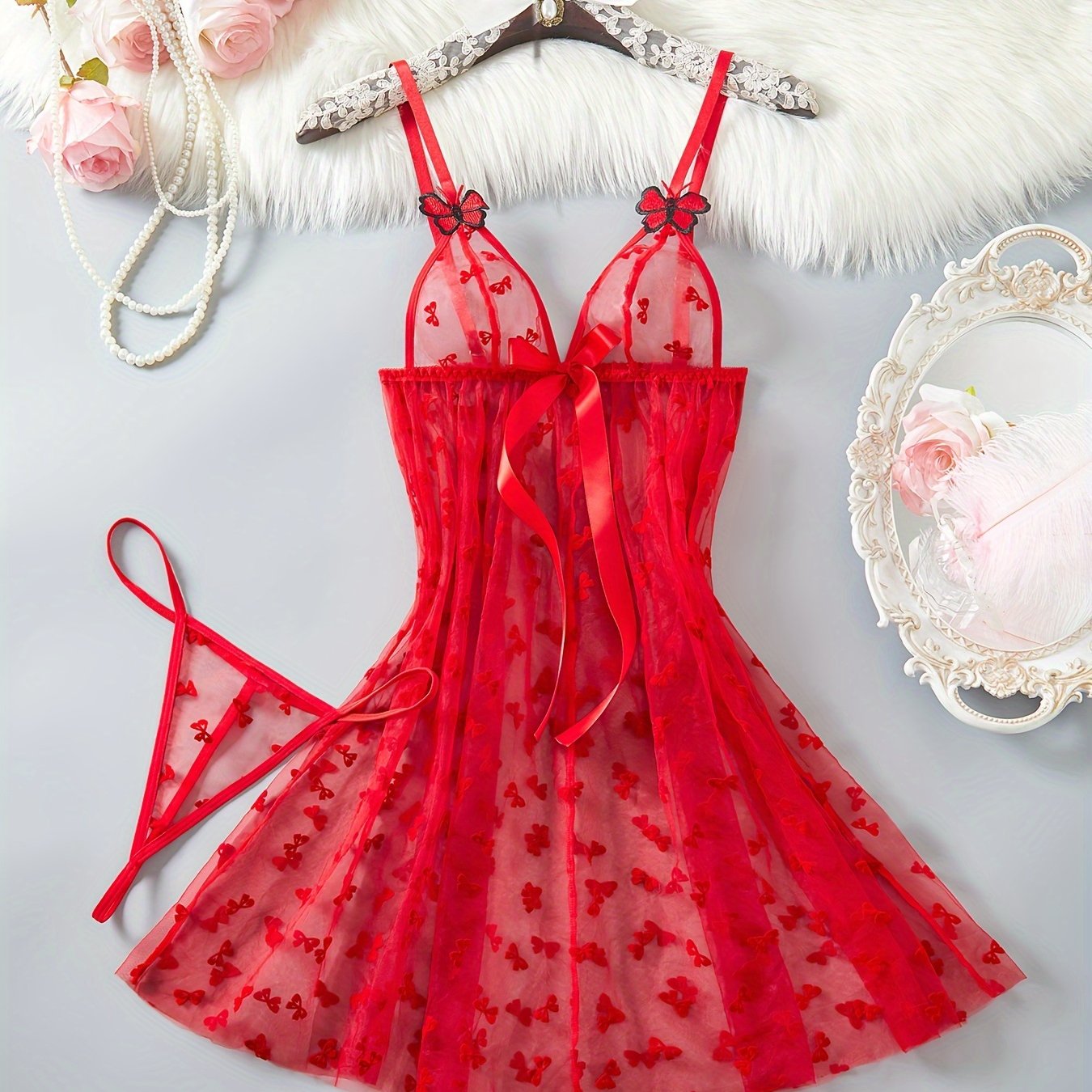 Elegant red mesh lingerie set for women with butterfly pattern babydoll and large bow detail. A sensual adult costume.